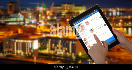 Composite 3d image of hands touching digital tablet against white background Stock Photo