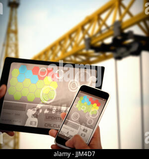 Composite 3d image of close up of hands using digital tablet and mobile phone Stock Photo