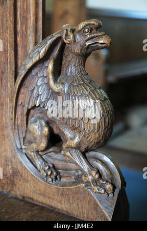 Carved wooden pew end figure,  Huntingfield church, Suffolk, England, UK Stock Photo