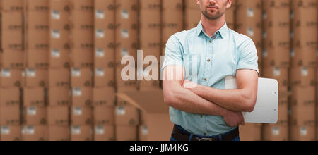 Composite image of serious warehouse manager standing with arms crossed Stock Photo