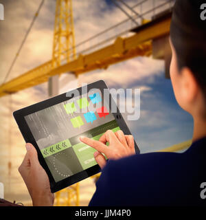 Composite 3d image of businesswoman working on digital tablet over white background Stock Photo
