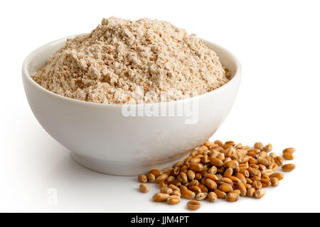 Spelt whole grain flour  in white ceramic bowl isolated on white. Spilled winter wheat kernels. Stock Photo