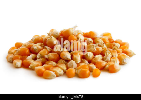 Heap of unpopped popcorn isolated on white. Stock Photo