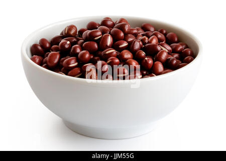 Dry adzuki beans  in white ceramic bowl isolated on white. Stock Photo