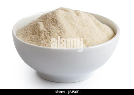 White flour  in white ceramic bowl isolated on white. Stock Photo
