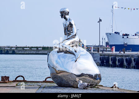ELSINORE, DENMARK - APRIL 30, 2016: The sculpture Han, meaning He, by danish artists  Elmgreen and Dragset, made of polished stainless steel, on the o