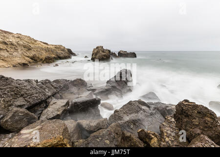 Rocky Leo Carrillo State Beach with motion blur water in Malibu, California. Stock Photo