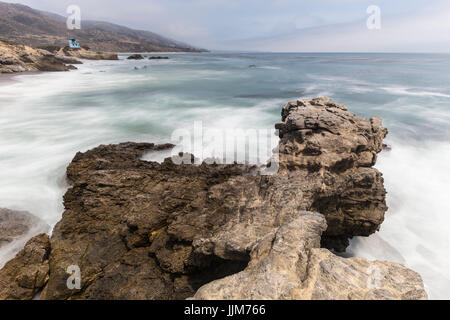 Leo Carrillo State Beach rocky point with motion blur surf in Malibu, California. Stock Photo