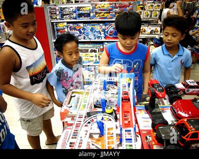 TAYTAY CITY, PHILIPPINES - JULY 15, 2017: Children play with toys in a toy store in SM City mall in Taytay City, Philippines. Stock Photo