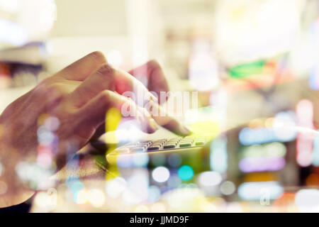 Computer networking,using computer double exposure and blurred view of car on street at night Stock Photo