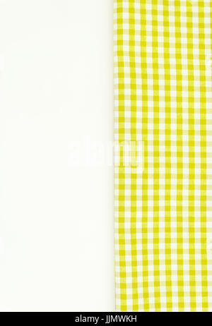 Yellow fabric, kitchen towel with checkered pattern, isolated on white background isolated. Stock Photo