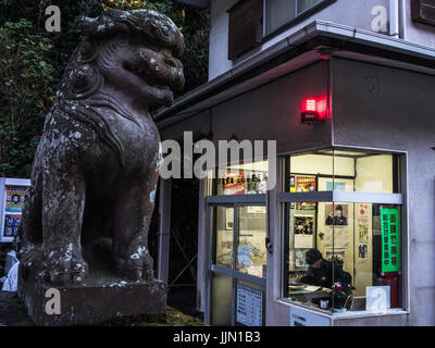 Komainu lion dog guardian statue near koban poilce station, night, Enoshima, Kanagawa, Japan Stock Photo