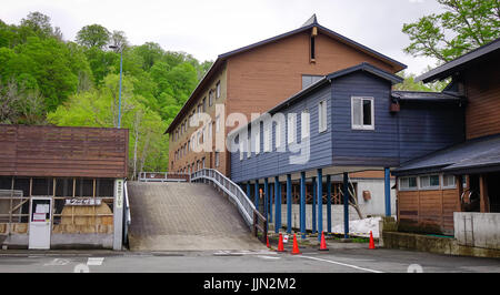 Tohoku, Japan - May 17, 2017. Wooden cottage at Tamagawa Hot Spring in Tohoku, Japan. Tamagawa is located in a valley about 12 km west of the peak of  Stock Photo