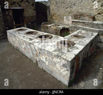 Italy. Pompeii. Marble covered counter Thermopolium.  Located between Cardo V and Lower Decumanu. Campania. Stock Photo