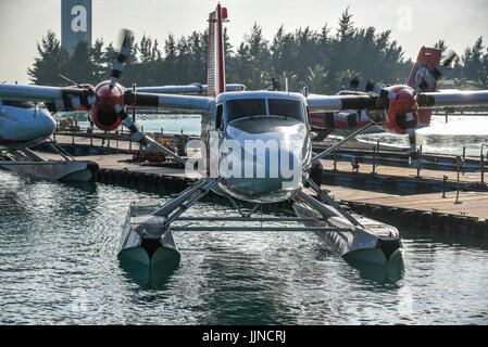A Trans Maldivian Airways seaplane begins to taxi towards the take-off area at the Seaplane Terminal at Male International Airport, Maldives. Stock Photo