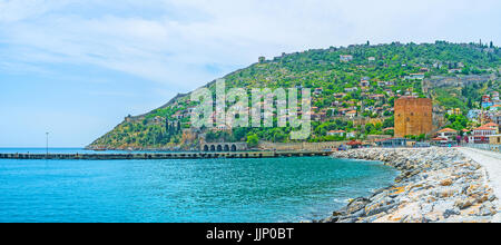 The pier in old marina is the perfect place for the walk and enjoy the views of the Red Tower and Alanya peninsula, Turkey. Stock Photo