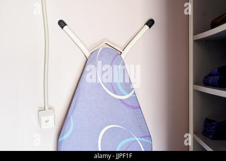 Ironing board in a dressing room Stock Photo