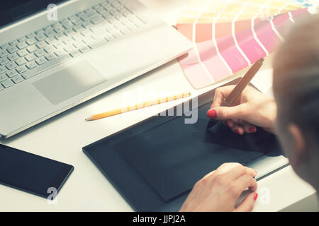 freelance graphic designer using digital drawing tablet Stock Photo