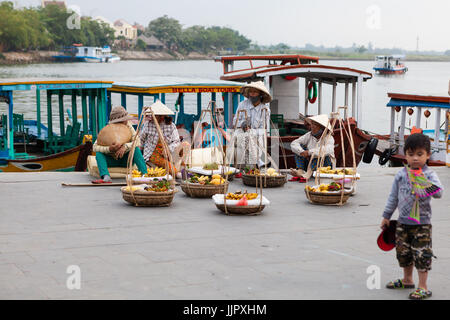 Hoi An, Vietnam - March 14, 2017: fruit sellers having a break Stock Photo