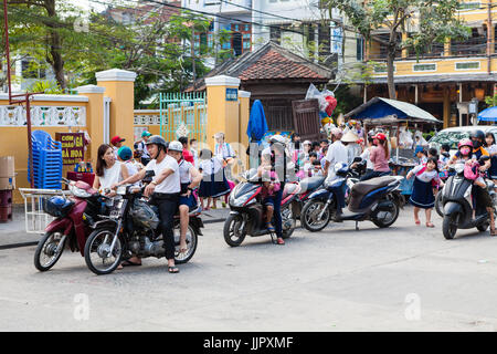 Hoi An, Vietnam - March 14, 2017: parents picking up their children from school Stock Photo