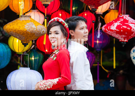 Hoi An, Vietnam - March 14, 2017: Vietnamese young couple in traditional wedding attire Stock Photo