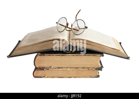 Vintage spectacles lying on old books. Isolated on white background with clipping path Stock Photo