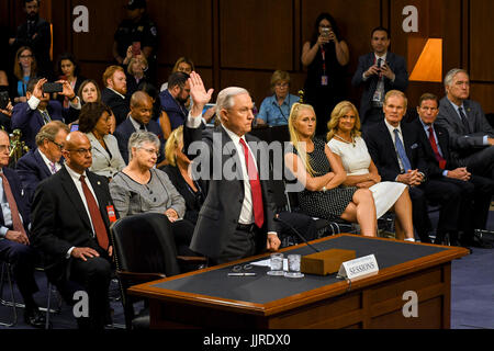 US. Attorney General Jeff Sessions raises his right as he prepares to be sworn in to testify in front of the Senate Intelligence Committee. Washington DC, June 13, 2017. Stock Photo