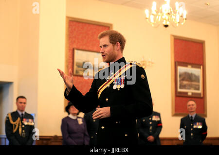 Prince Harry presents the Firmin Sword of Peace to the Royal Air Force Police during an official visit to RAF Honington in Bury St Edmunds.