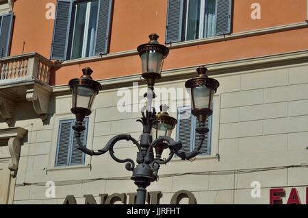 A beautiful Lamp post  having 4 lamps against backdrop of a building, Rome, Italy, Europe Stock Photo