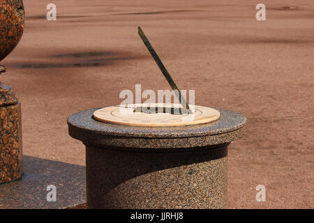 A sundial on a pedestal made of pink granite in the 17th century before the Gatchina Palace Stock Photo