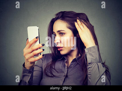 Closeup unhappy upset woman surprised she is losing hair has receding hairline. Human face expression emotion. Beauty hairstyle concept Stock Photo