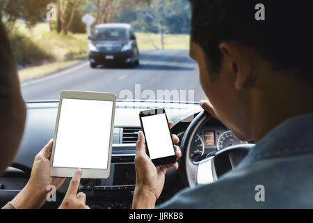 couple using phone inside car on rural road mobile app concept Stock Photo