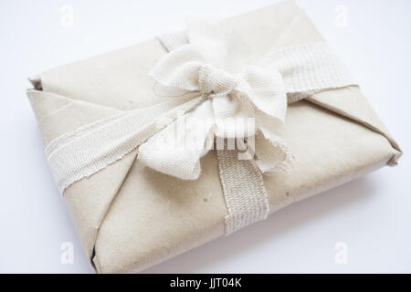 Download The package with eco vintage paper and linen tape and bow for a gift Stock Photo: 149273722 - Alamy