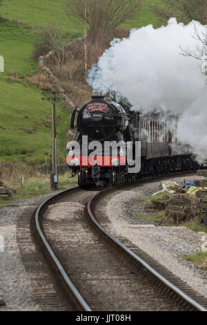 Iconic steam locomotive, LNER Class A3 60103 Flying Scotsman puffing smoke & traveling on tracks of Keighley and Worth Valley Railway, England, UK. Stock Photo