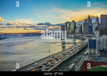 Manhattan Bridge and NYC Skyline during sunset with traffic Stock Photo