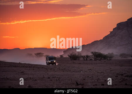 Safari vehicle returning to camp in evening, Namibia, Africa Stock Photo