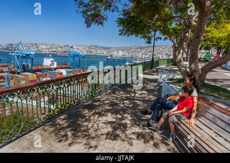 Valparaiso, Chile, January 11, 2017:  Tourists looking at view on the port of Valparaiso from Paseo Artilleria. Stock Photo