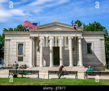 Bunker Hill Monument with American flag waving against blue sky, Charlestown, Boston, Massachusetts, USA Stock Photo