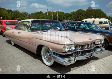 DEN BOSCH, THE NETHERLANDS - MAY 10, 2015: Pink 1959 Cadillac Sedan De Ville classic car. Stock Photo