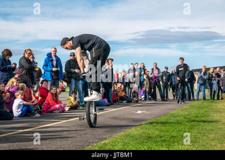 Jason Auld of Team Voodoo unicycles performing a stunt leap at Wheels and Wings event 2016, East Fortune, East Lothian, Scotland, UK Stock Photo