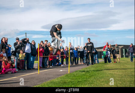 Jason Auld of Team Voodoo unicycles performing a stunt leap at Wheels and Wings event 2016, East Fortune, East Lothian, Scotland, UK Stock Photo
