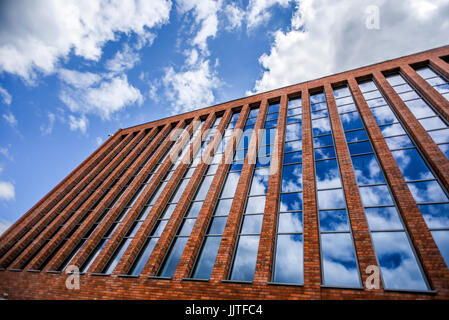 Szczecin, Poland, July 17, 2017: Modern architecture combining brick and glass on sky background in Szczecin. Stock Photo