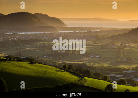 A summer sunset over Conwy in north Wales. The view is looking towards Conwy, Llandudno Junction and the Isle of Anglesey in the distance. Stock Photo