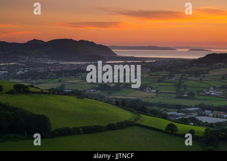 A summer sunset over Conwy in north Wales. The view is looking towards Conwy, Llandudno Junction and the Isle of Anglesey in the distance. Stock Photo