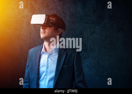 Virtual reality and futuristic technology in modern business, businessman with VR headset using new tech gadgets to develope and manage entrepreneursh Stock Photo