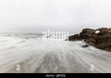 Rocky Leo Carrillo State Beach with motion blur water in Malibu, California. Stock Photo