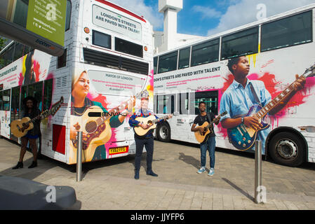 London, United Kingdom. 21th July 2017. Kal Lavelle, Jay Johnson and Modupe Obasola attends the Launch of International Busking Day & next phase of Mayor’s Gigs competition.  Dire Straits frontman Mark Knopfler unveils two iconic London buses to celebrate launch of Gigs, in association with Gibson, on the eve of International Busking Day. Gigs enters its next phase today with performances taking place around the city   Young musicians competing to be named the capital’s top buskers will perform aboard two specially commissioned London buses this weekend to help mark International Busking Day,  Stock Photo