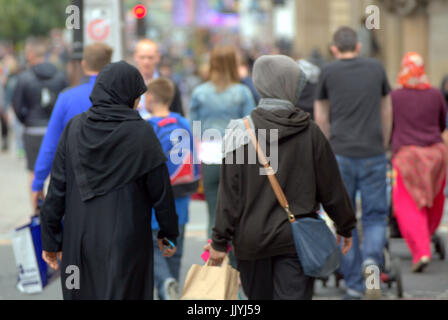 Asian refugee dressed Hijab scarf on street in the UK everyday scene Stock Photo