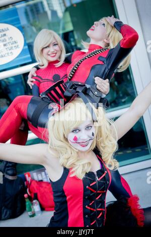 Cosplayer Carol from Santa Clarita as 'Harley Quinn', Victoria as 'Spider-Man' holding Juliey as Deadpool, all from Santa Clarita, at the Comic-Con San Diego, in July 2017. | usage worldwide Stock Photo