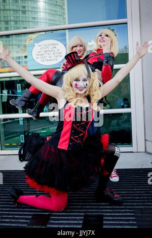 Cosplayer Carol from Santa Clarita as 'Harley Quinn', Victoria as 'Spider-Man' holding Juliey as Deadpool, all from Santa Clarita, at the Comic-Con San Diego, in July 2017. | usage worldwide Stock Photo